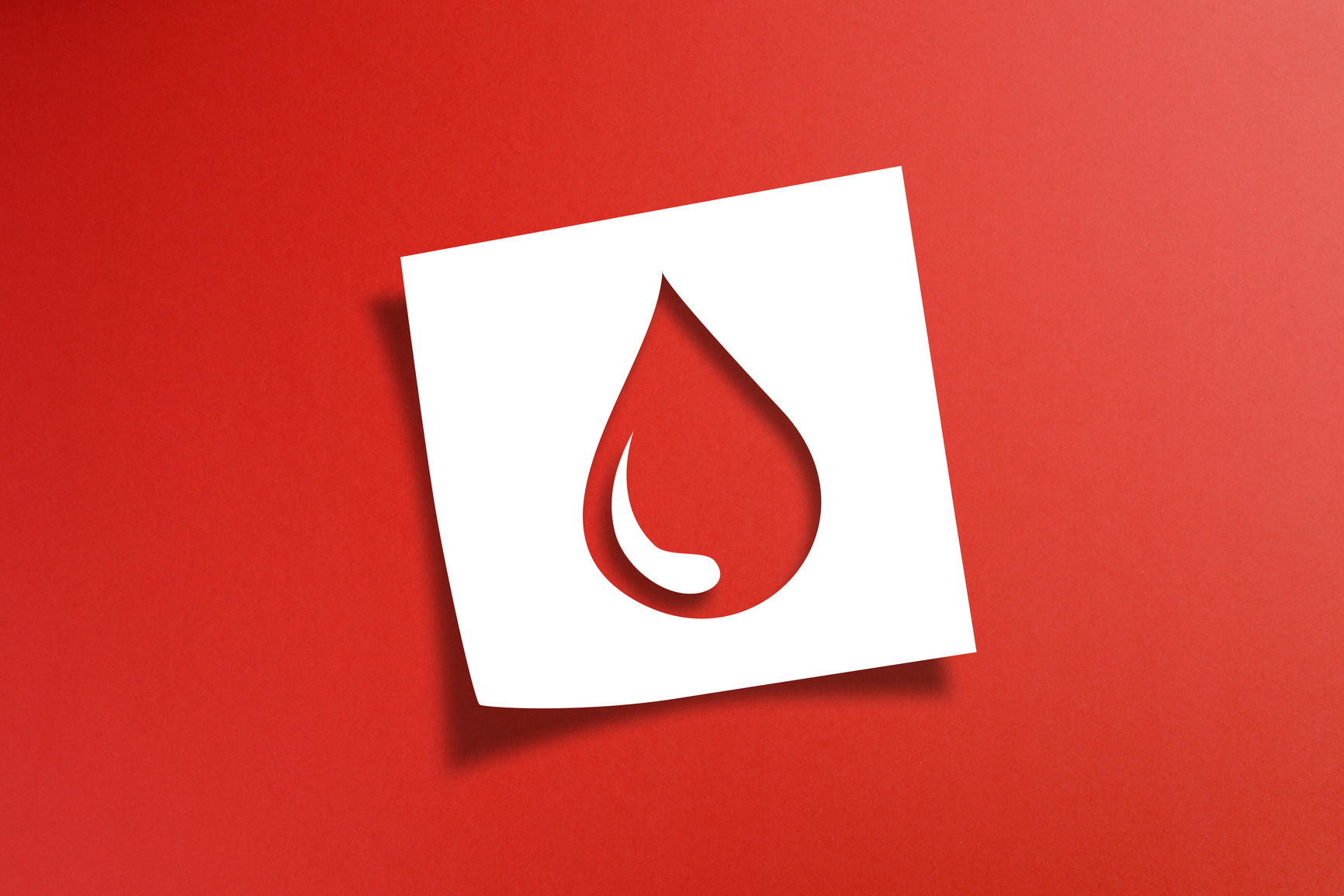 Note paper with blood donation concept on red background
